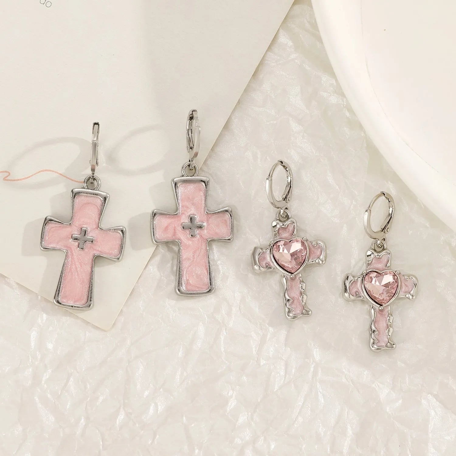 Women's alloy earrings in cross, heart and animal designs with multiple colour options
