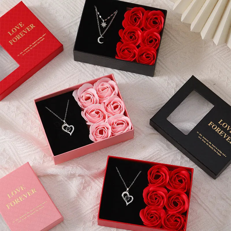Red Korean style soap flower gift set with six roses in a box next to a matching handbag.