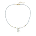 White shell bead necklace with a mother pearl pendant on a silver-toned chain.
