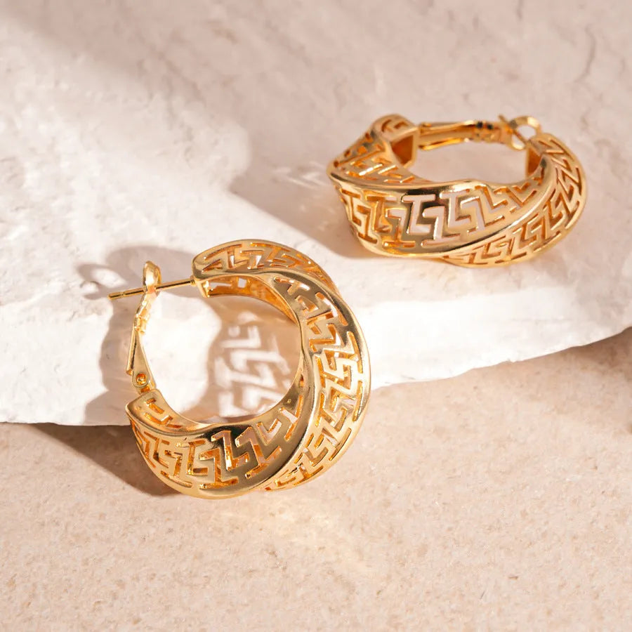 Women's geometric hollow stud earrings with twisted round design in silver or gold finish