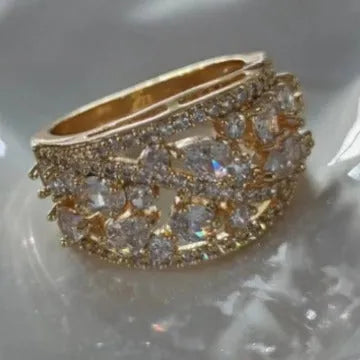 Women's round hollow copper fashion ring with a choice of platinum or gold finish and white or blue stone.