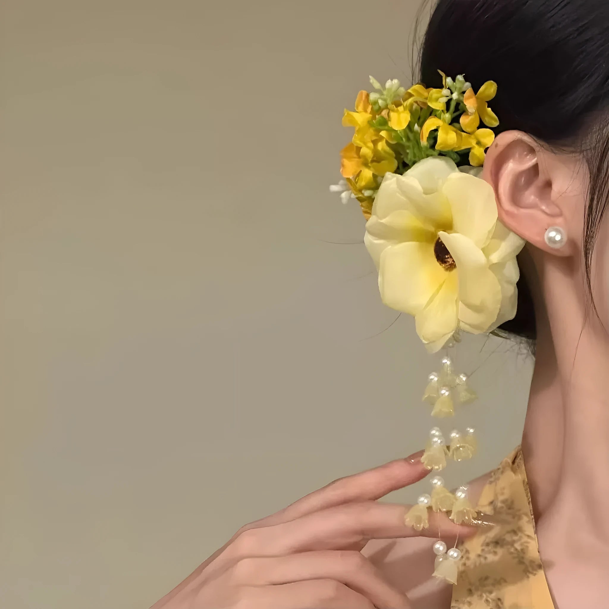 Close-up of a handcrafted hair clip with a colourful flower tassel decoration on a side-clip base.