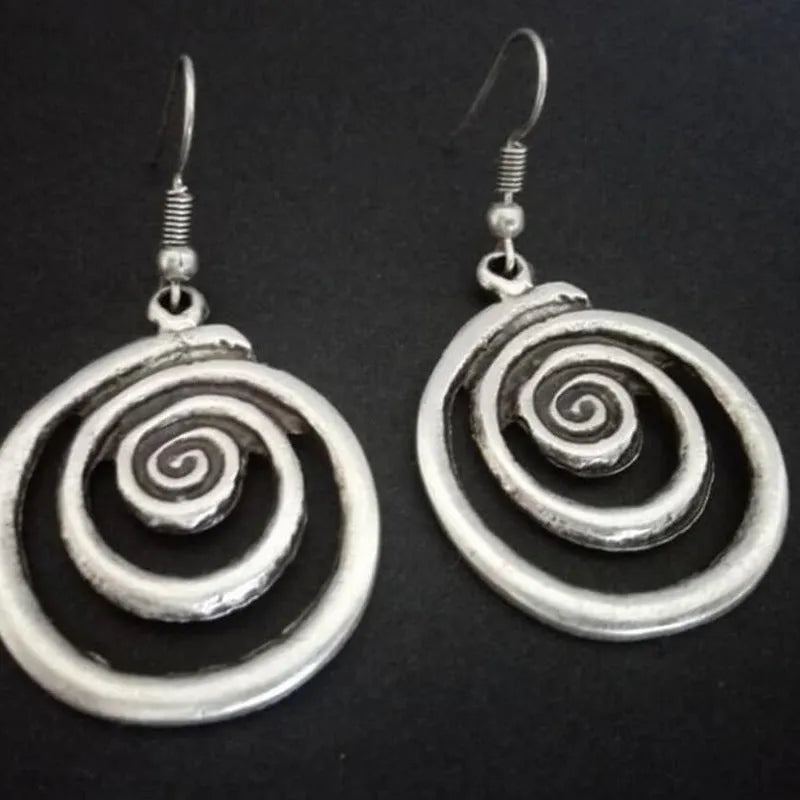 Silver geometric spiral earrings with distressed finish measuring 2.6 by 5 centimetres