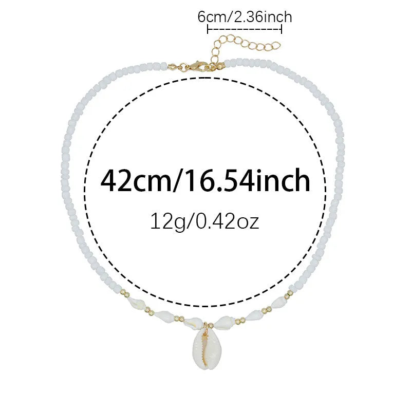 White shell bead necklace with a mother pearl pendant on a silver-toned chain.