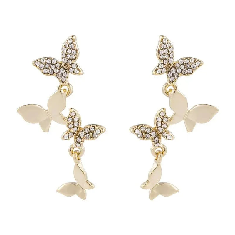 Women's butterfly drop earrings in copper with gold finish showing four butterfly design