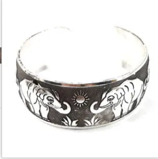 Silver Miao ethnic carved open bracelet with elephant motif on alloy metal