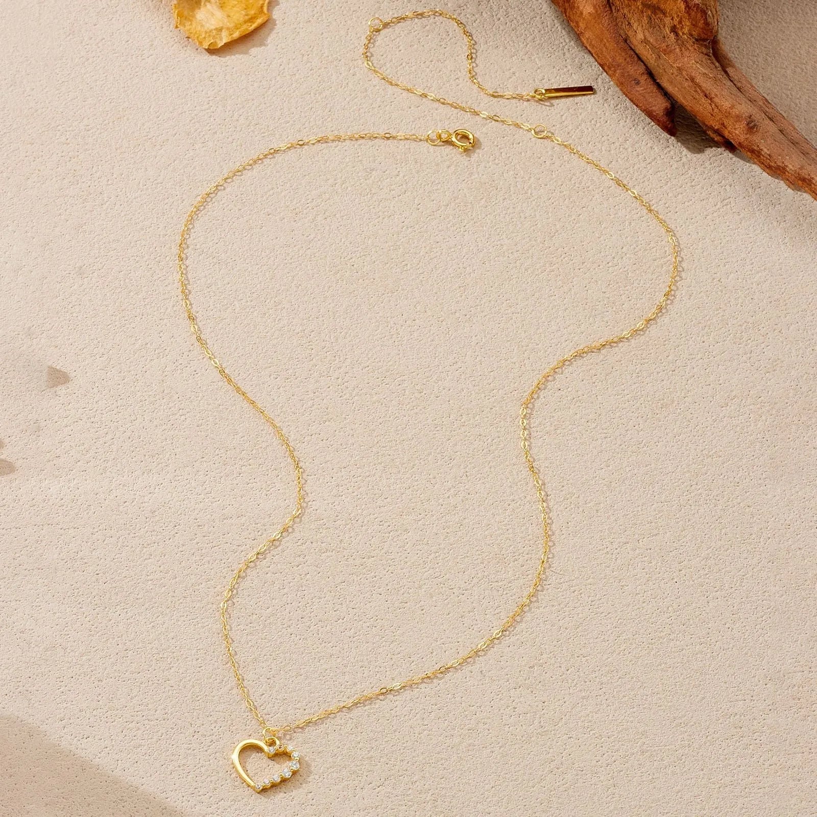 S925 sterling silver hollow heart necklace on a model, showing white gold and 18K gold plated finish options.