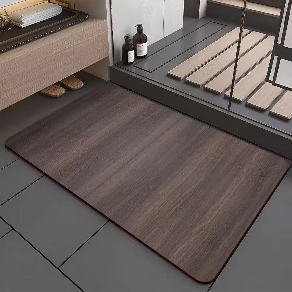 Square diatom mud bathroom floor mat with a brown wood grain geometric pattern on a tiled floor.