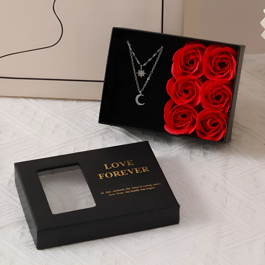 Red Korean style soap flower gift set with six roses in a box next to a matching handbag.