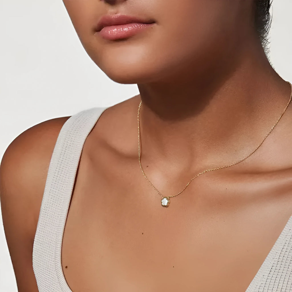 White mother of pearl flower pendant necklace on a gold-coloured chain for women.