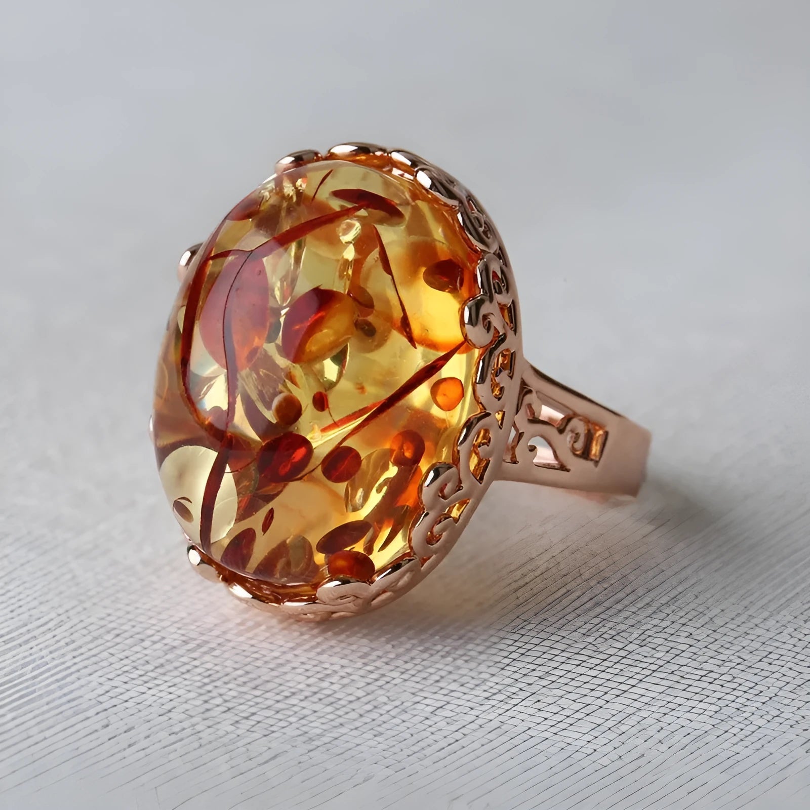 Adjustable beeswax amber ring in New Amber Type A colour on an alloy band.