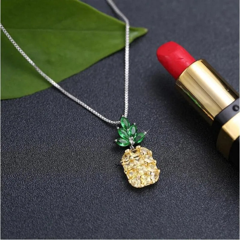 Silver geometric pineapple pendant necklace with diamond crystal details on women's model