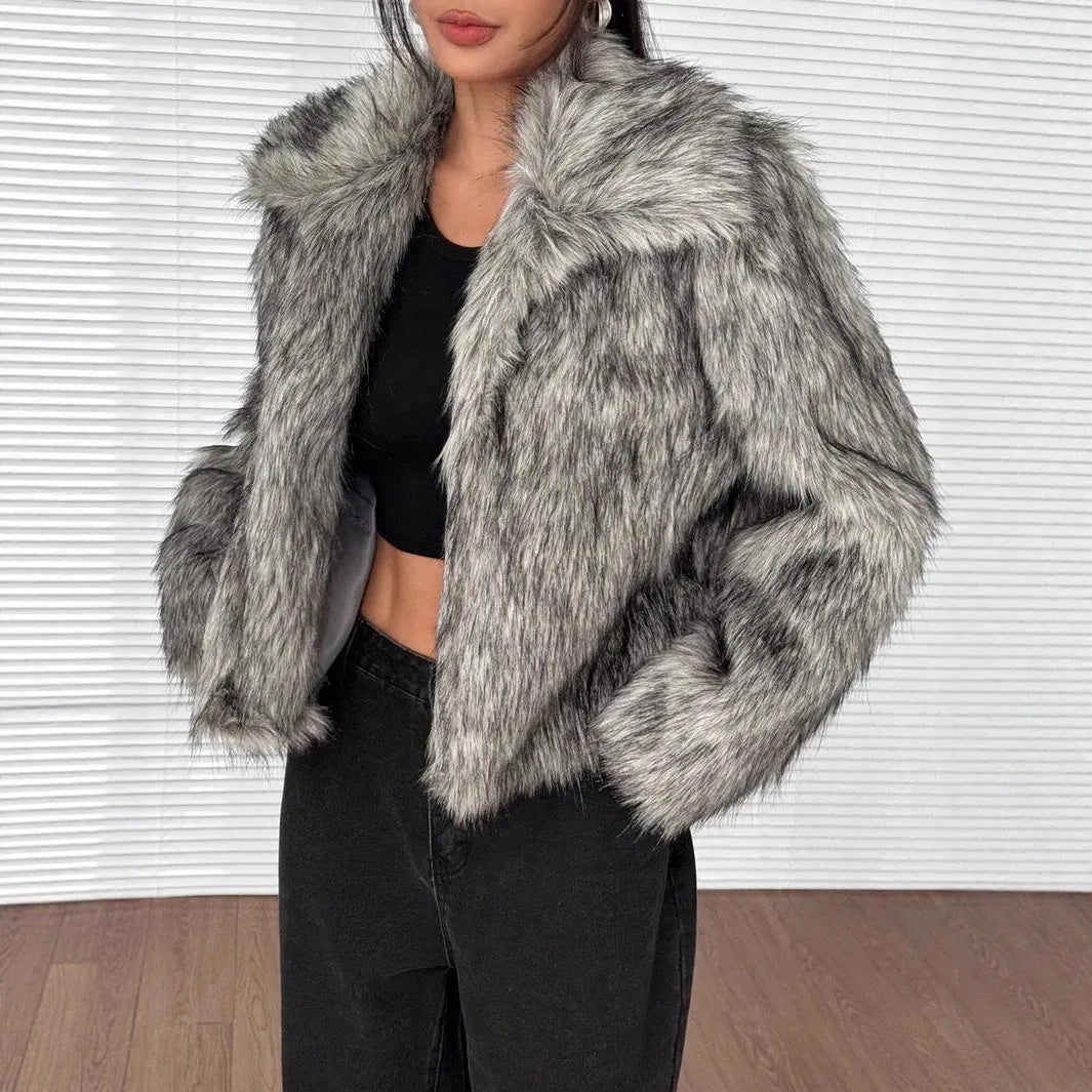 Women's short black artificial fur coat with a full fur collar and long sleeves.