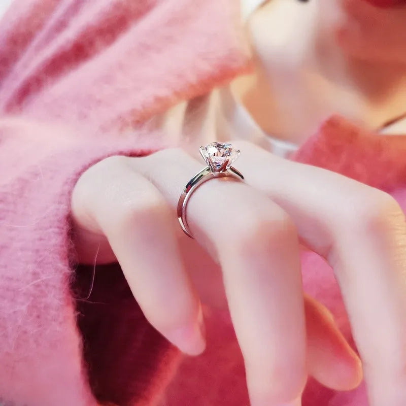 White gold plated geometric ring with a six-claw setting holding a zircon stone.