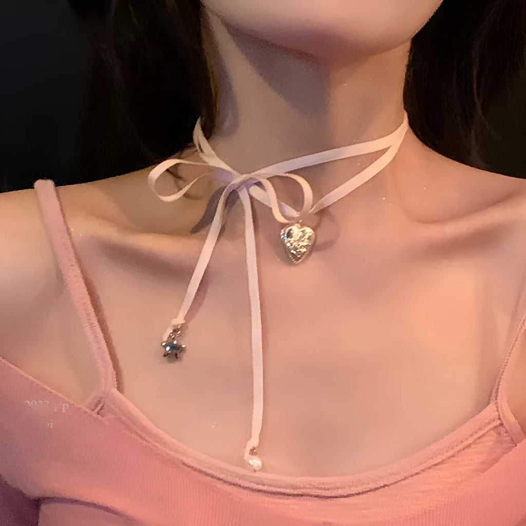 Women's ribbon pendant necklace with alloy chain and electroplated finish showing clavicle length