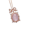 Geometric silver pendant necklace with a pink rose quartz crystal and rose gold plating.