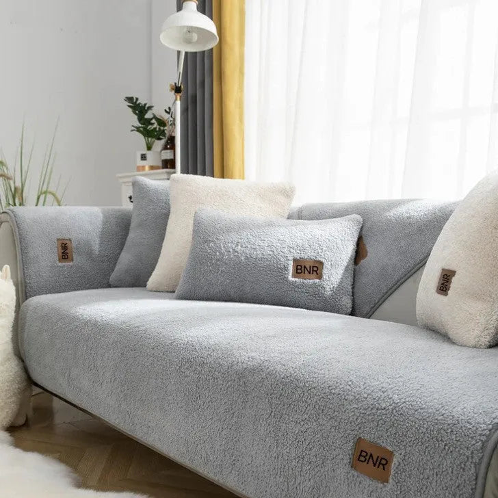 Solid colour lambswool sofa cover on a couch with matching pillow cover.