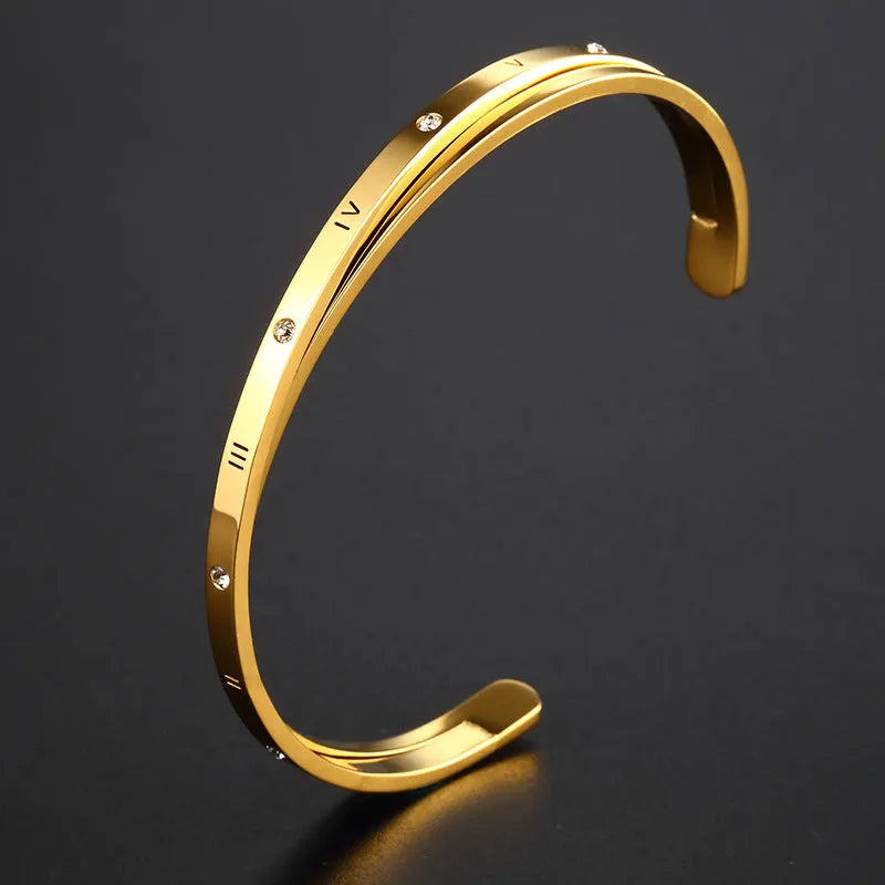 Open-ended women's bracelet in stainless steel with electroplated finish and inlaid zircon stones.