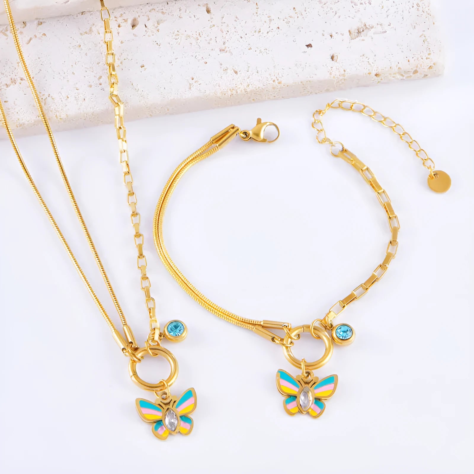 Gold-coloured titanium steel butterfly jewellery set with necklace and bracelet showing epoxy resin pendants