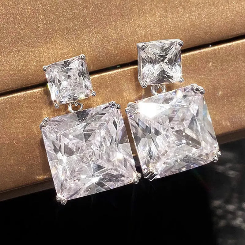 A pair of copper geometric square earrings with a quadrilateral design in a gold colour finish.