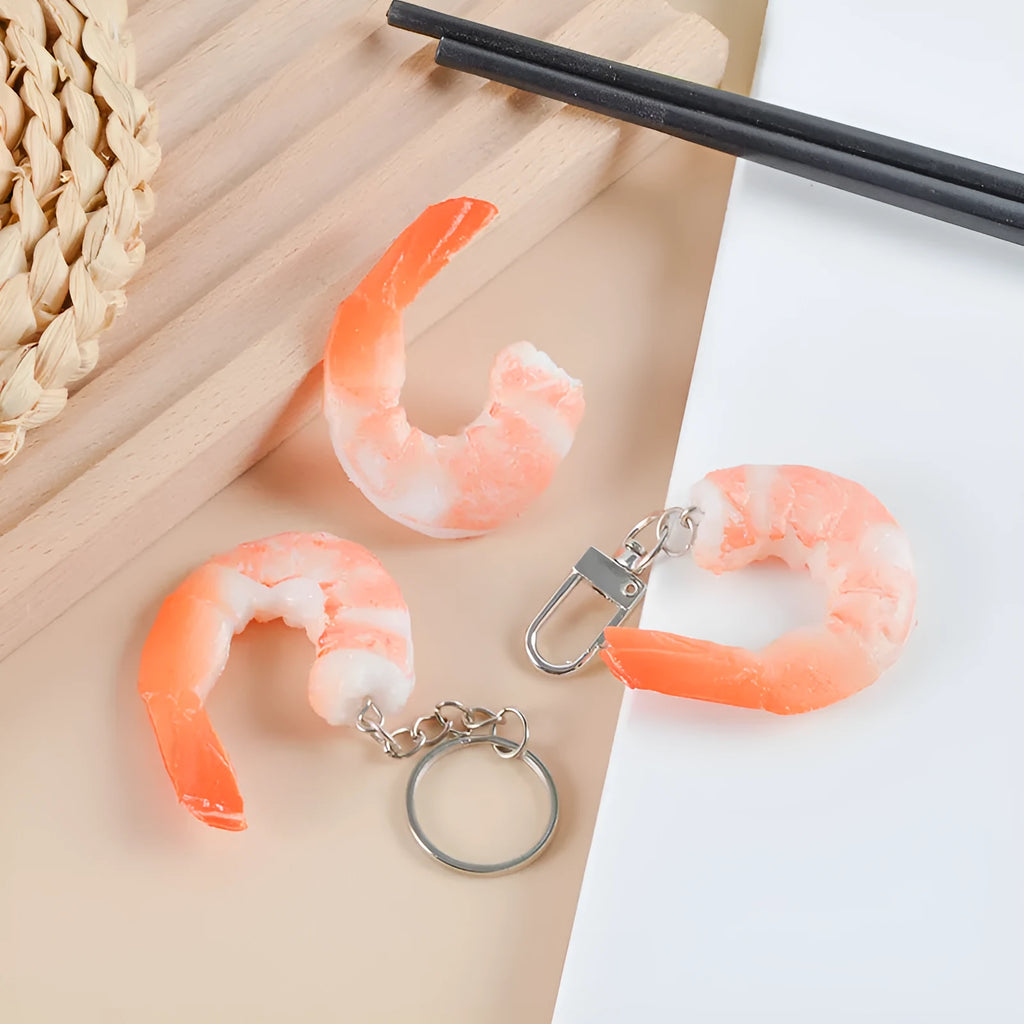 Close-up of a white simulation shrimp PVC keychain pendant showing its 1.5cm thickness.