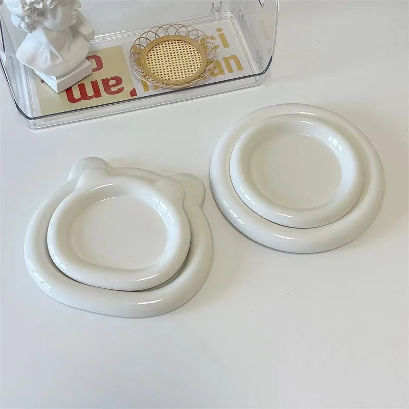 White ceramic chubby toot plate with doodle design, shown in bear and round styles.
