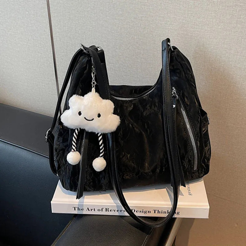 Women's soft black PU fashion backpack with adjustable straps and a silver pendant.