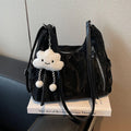 Women's soft black PU fashion backpack with adjustable straps and a silver pendant.