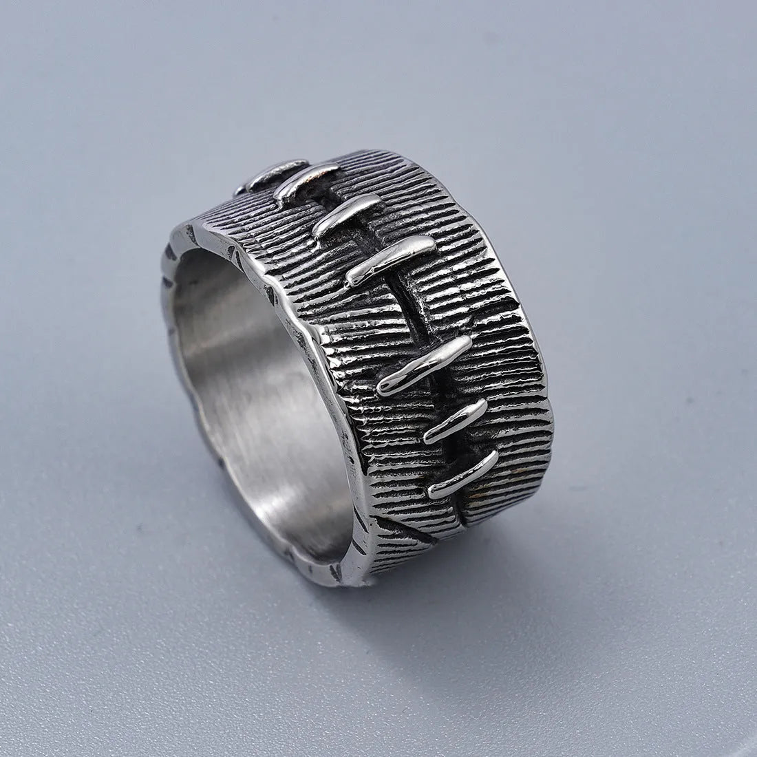 Geometric U-shaped titanium steel punk ring with double-ring design and stitched texture in black.