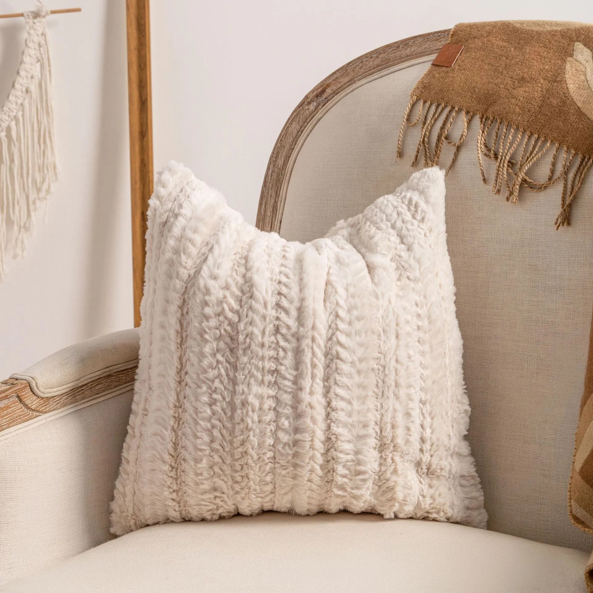 Knitted cushion cover with tassel trim in a striped pattern, shown in a choice of colours including spiral dots and woven rabbit fur.