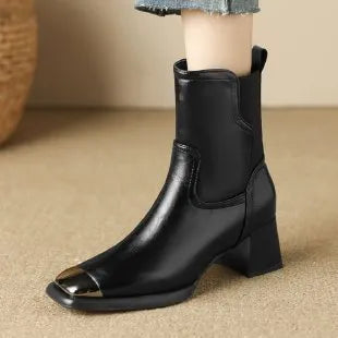 Women's brown Martin boots with high heel, side zipper, and decorative metal details on leather upper