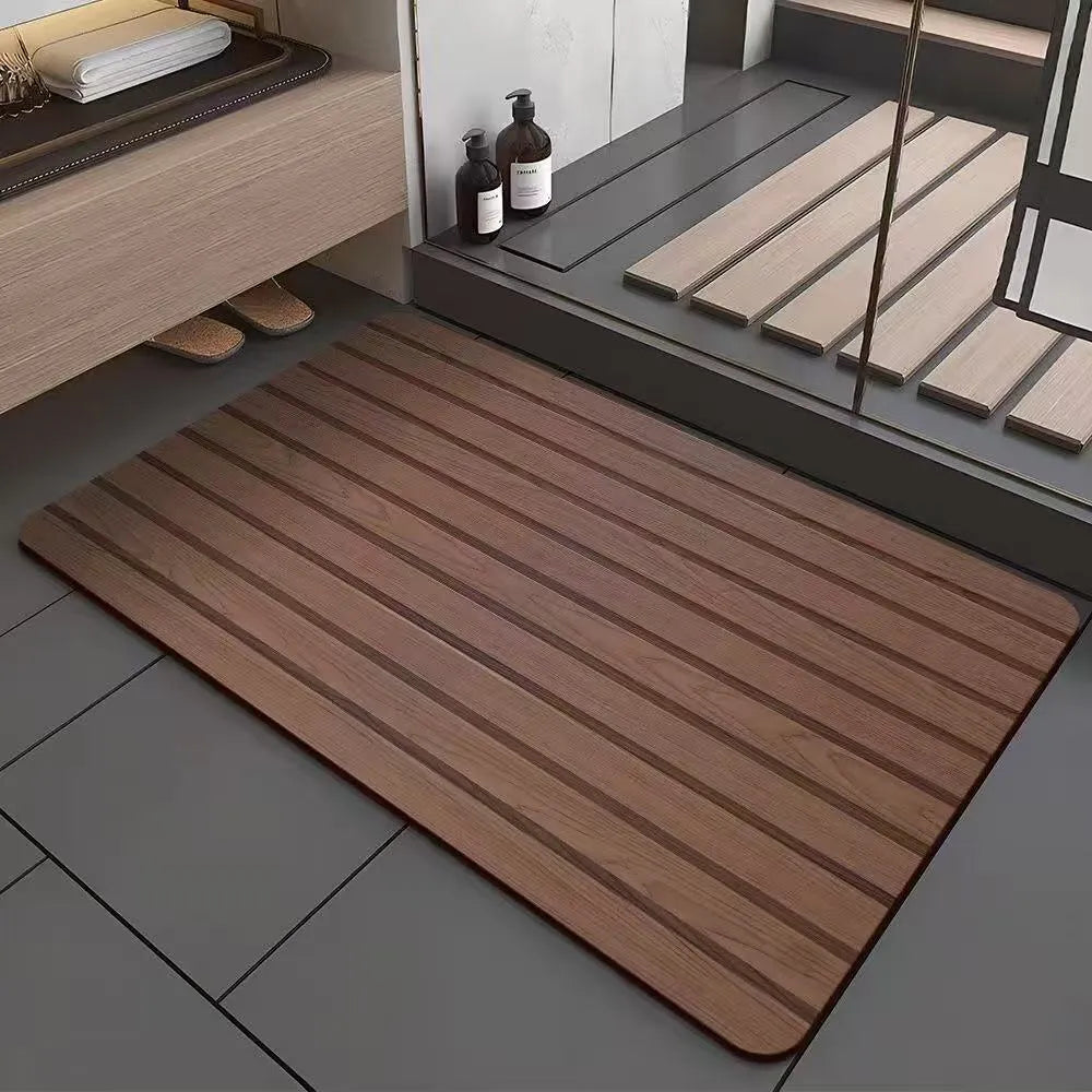 Square diatom mud bathroom floor mat with a brown wood grain geometric pattern on a tiled floor.