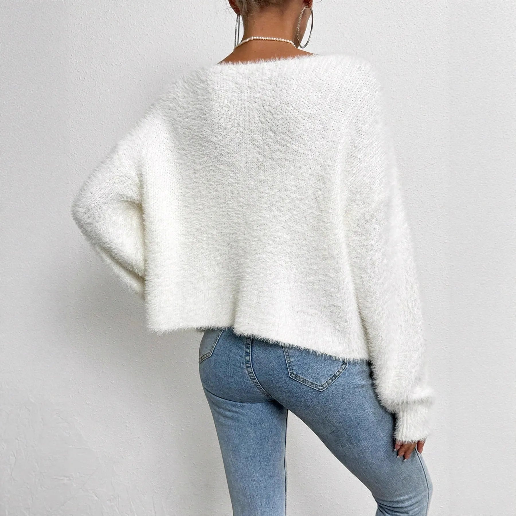 White women's V-neck cardigan sweater in polyester knit fabric