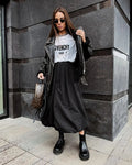 Women's solid colour cotton midi skirt in black or white showing long length