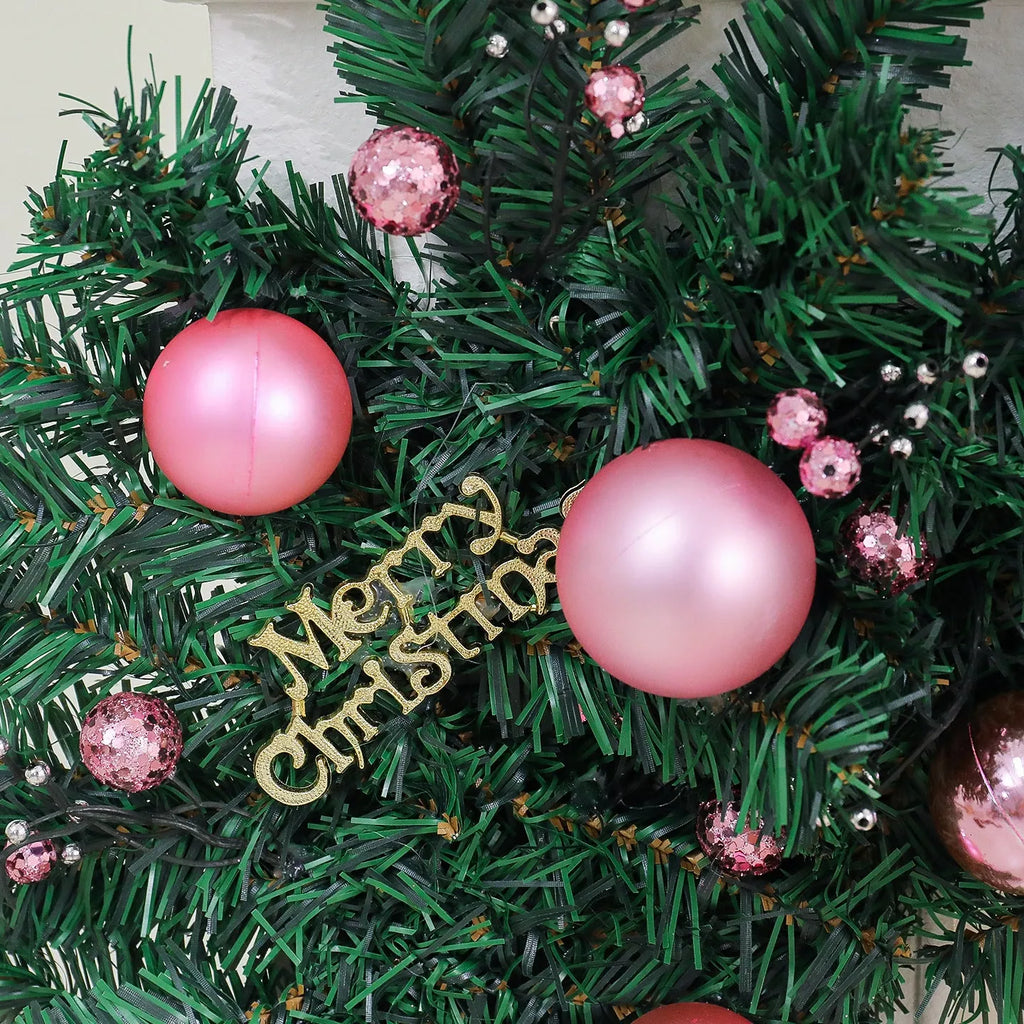 2.7 metre pink small fruit Christmas rattan garland with wrought iron frame draped along wall