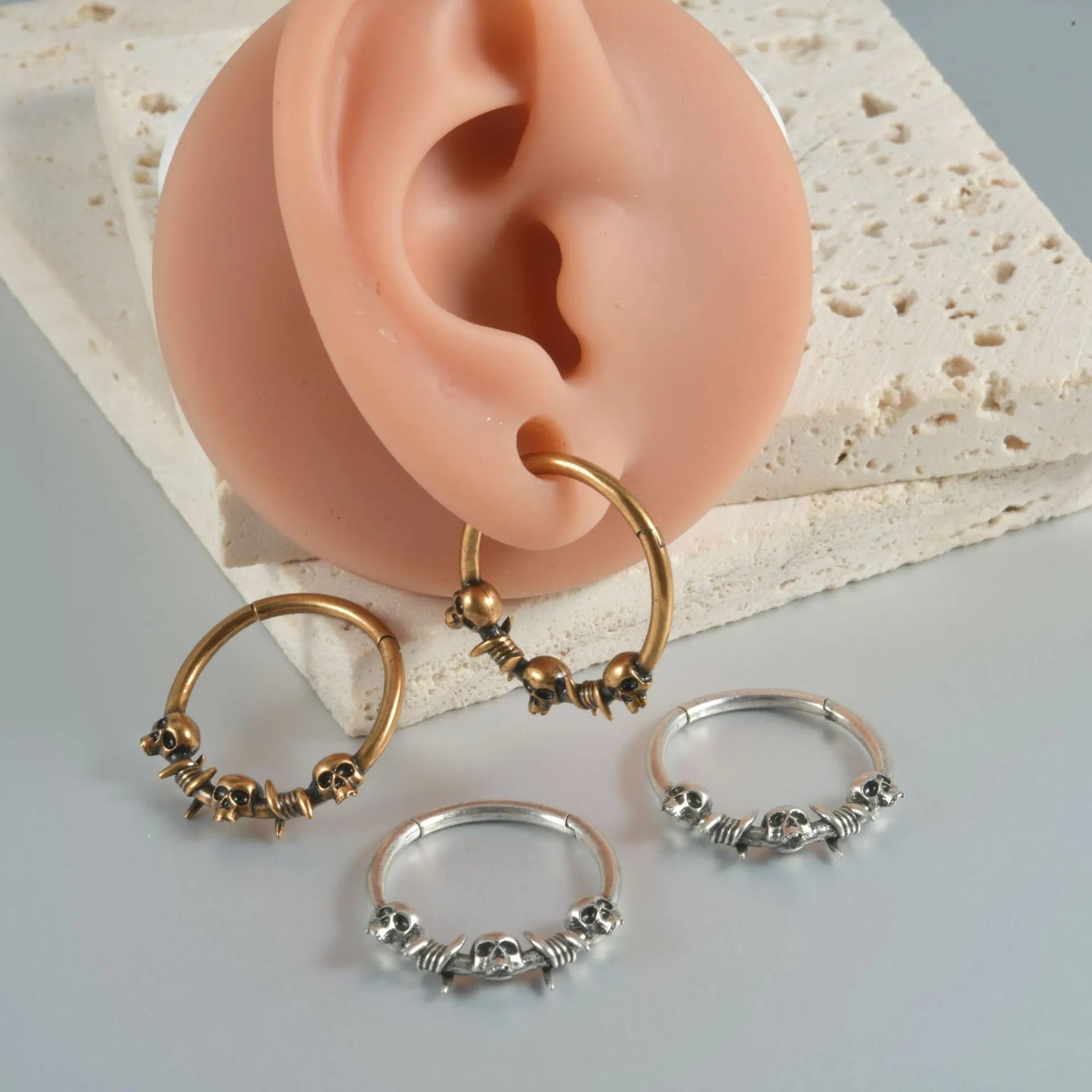 Punk copper earrings with antique ghost head designs in gold and silver finishes