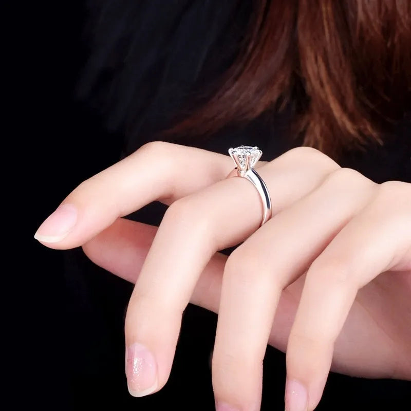 White gold plated geometric ring with a six-claw setting holding a zircon stone.