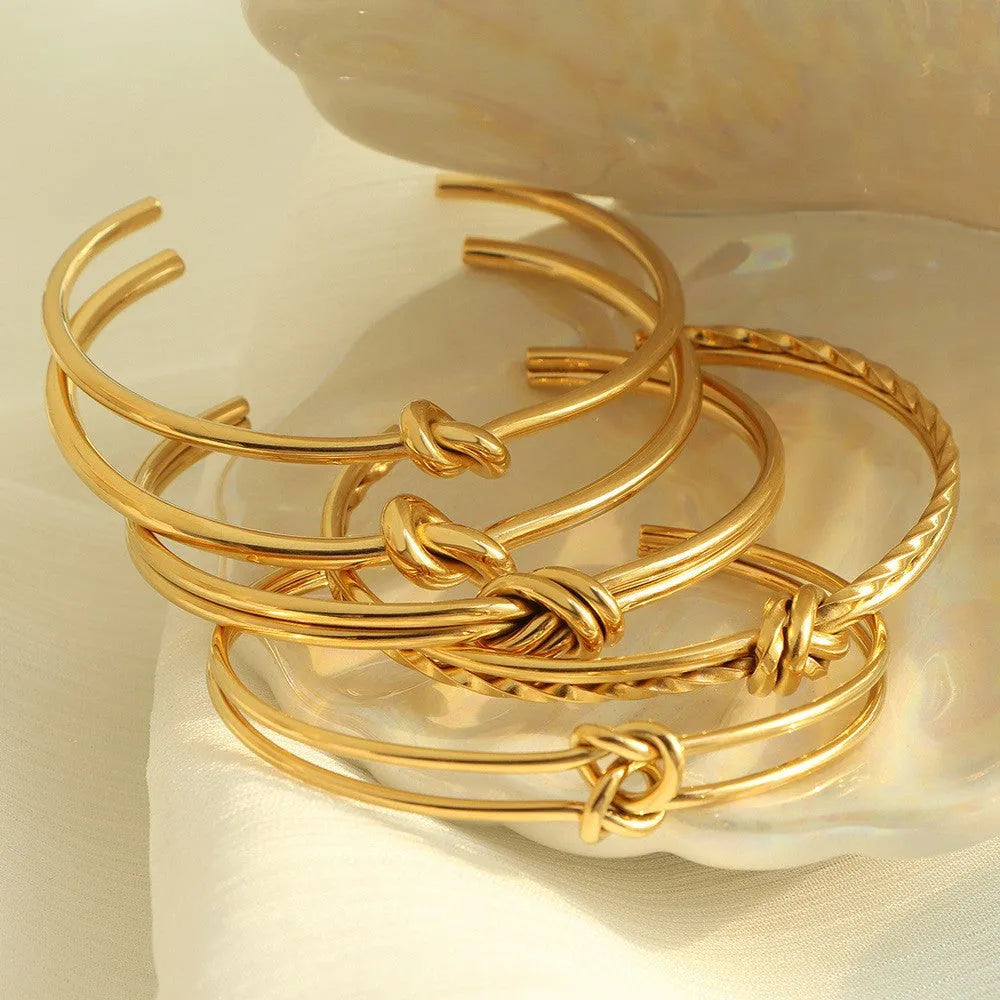 Women's stainless steel bracelet with knotted C-shaped open design in gold plating