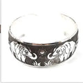 Silver Miao ethnic carved open bracelet with elephant motif on alloy metal