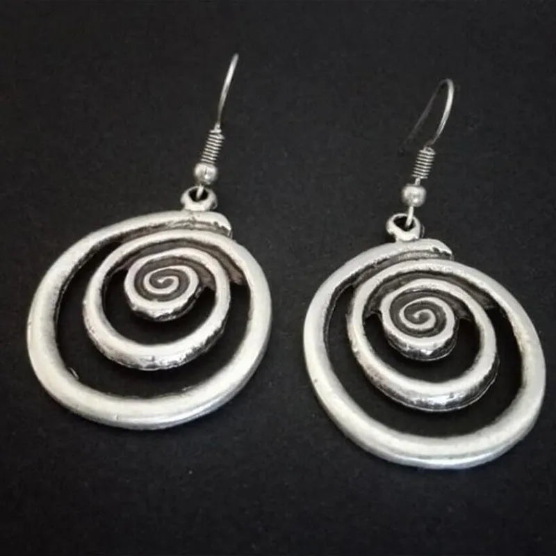 Silver geometric spiral earrings with distressed finish measuring 2.6 by 5 centimetres