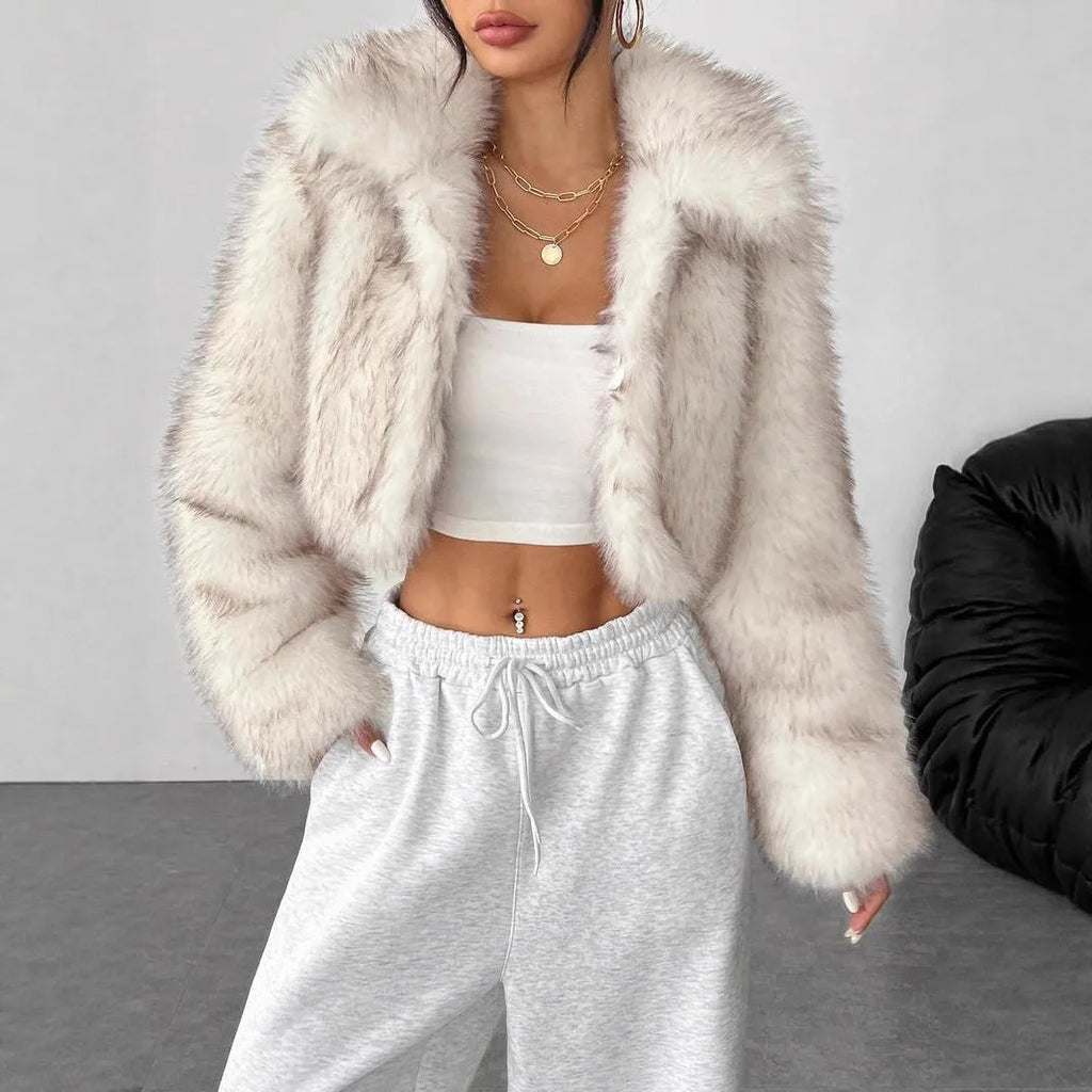 Women's short black artificial fur coat with a full fur collar and long sleeves.