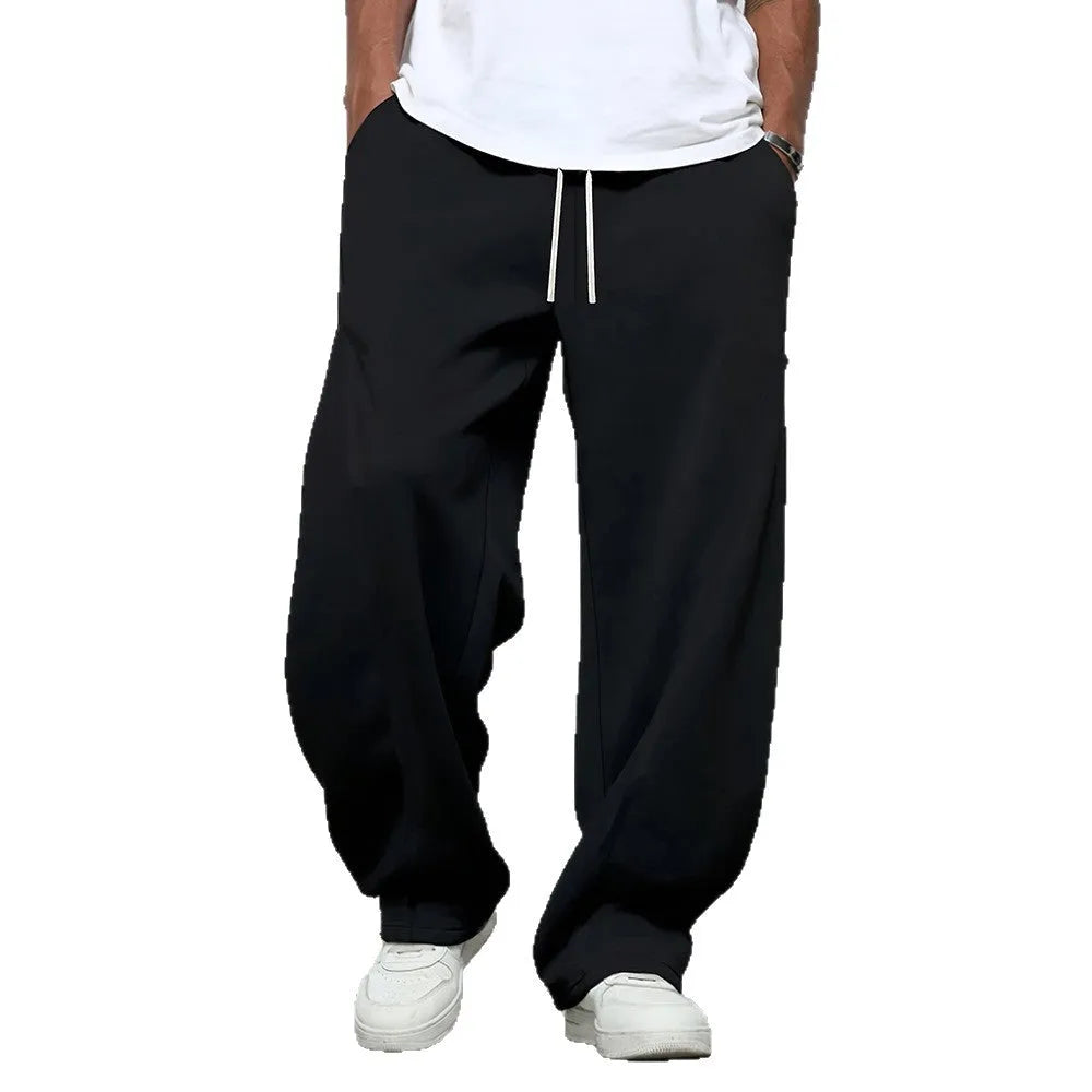 Man wearing solid-colour straight-leg polyester casual trousers with a drawstring waist.
