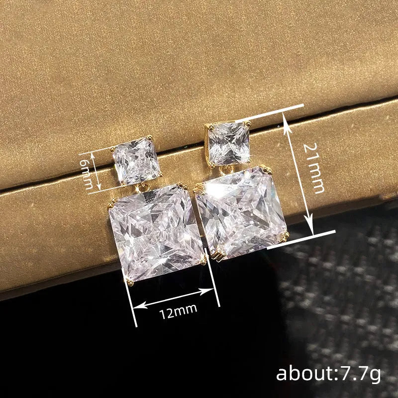 A pair of copper geometric square earrings with a quadrilateral design in a gold colour finish.