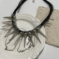 Leather necklace with winding tassel, round beads and point rivet details in electroplated picture colour