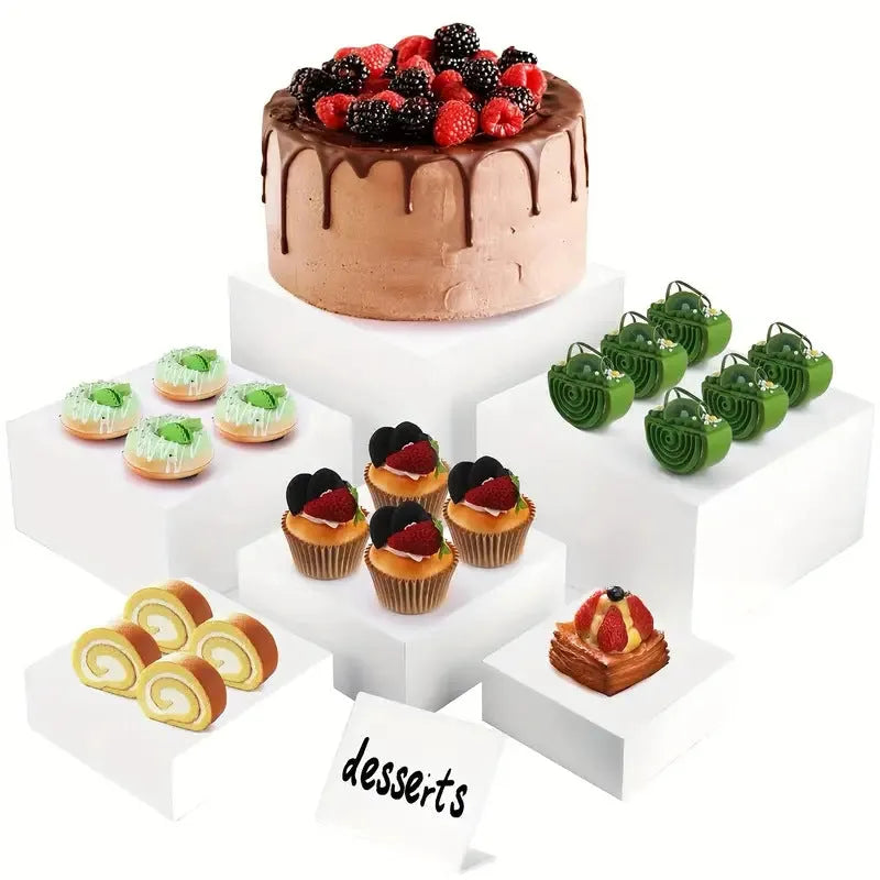 White plastic cube-style dessert display stand with six pieces for cupcakes and cakes.