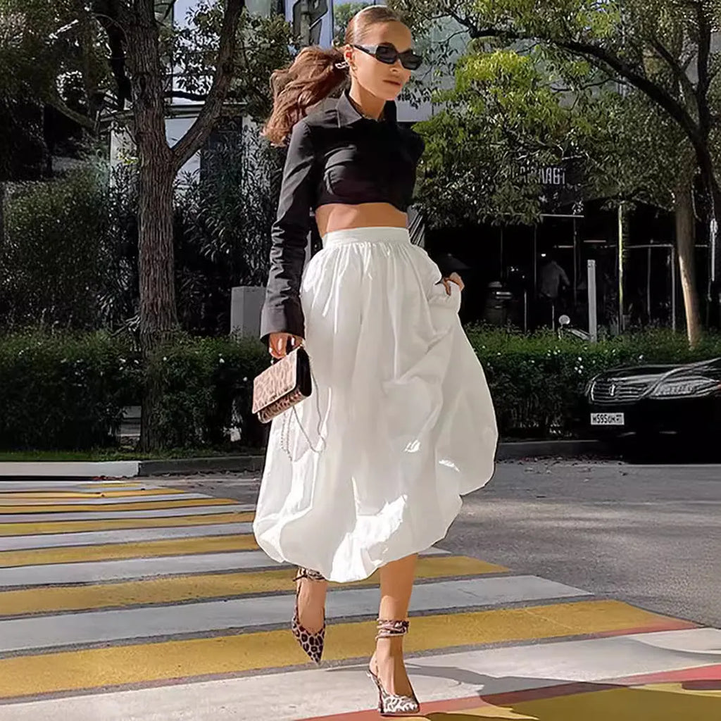 Women's solid colour cotton midi skirt in black or white showing long length