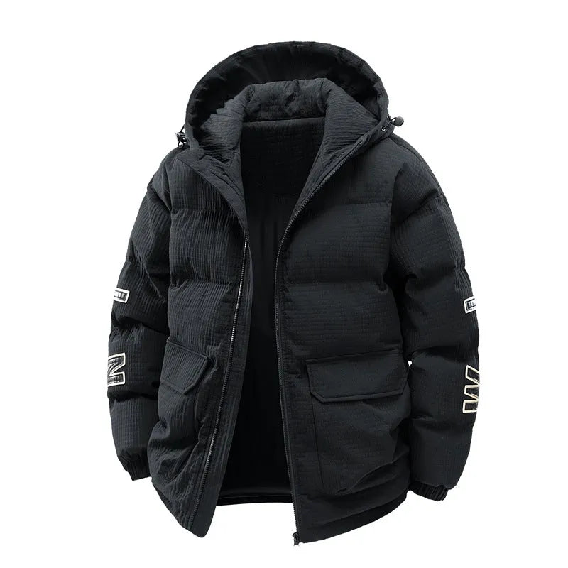 Man wearing a black hooded padded long coat with side pockets and a cardigan style.