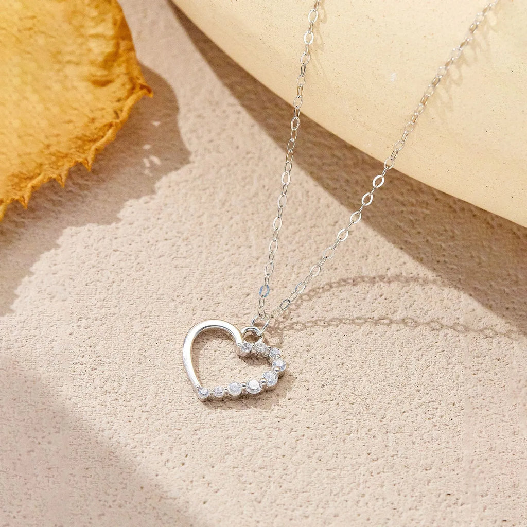 S925 sterling silver hollow heart necklace on a model, showing white gold and 18K gold plated finish options.