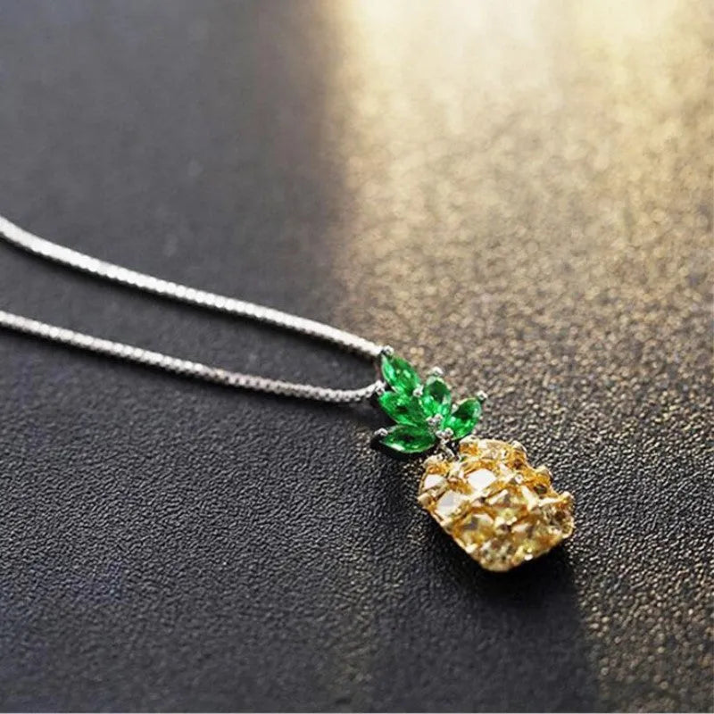 Silver geometric pineapple pendant necklace with diamond crystal details on women's model