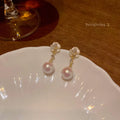 Close-up of camellia flower stud earrings for women showing alloy metal construction and floral detailing